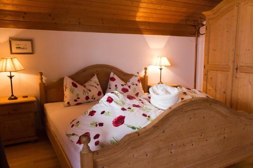 a bedroom with a wooden bed with pillows at Schwaningerhof in Cermes