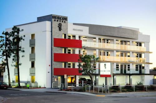 a white building with red accents on it at Hercor Hotel - Urban Boutique in Chula Vista