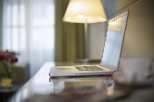 a laptop computer sitting on top of a desk at Boutique Hotel Das Tigra in Vienna