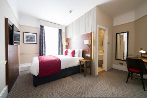 a hotel room with a bed and a desk at Miller & Carter Maidstone by Innkeeper's Collection in Maidstone