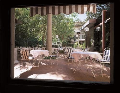 a group of tables and chairs sitting on a patio at Hotel Croce Di Malta in Florence
