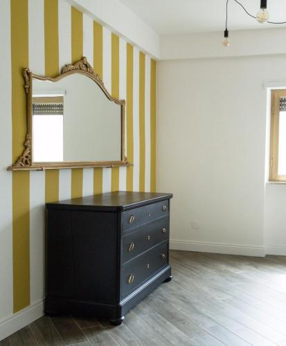 a black dresser in a room with a mirror at b&b Aurora in Atina