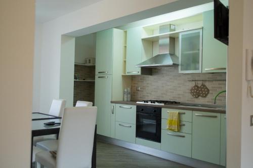 a kitchen with white cabinets and a stove top oven at b&b Aurora in Atina