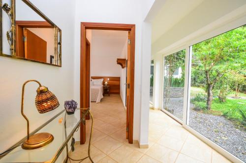 a hallway with a mirror and a door to a room at La Réserve Suites in Monte Verde