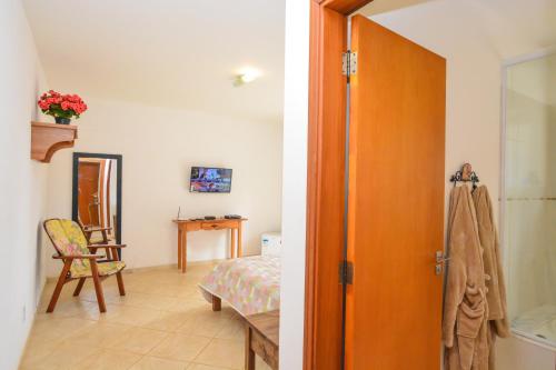 an open door to a room with a bedroom at La Réserve Suites in Monte Verde