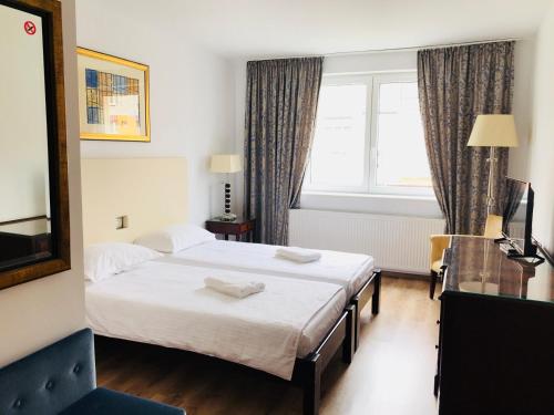 Ένα ή περισσότερα κρεβάτια σε δωμάτιο στο Hotel EKA