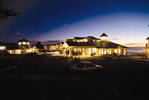 a house with a car parked in a parking lot at night at WorldMark Depoe Bay in Depoe Bay