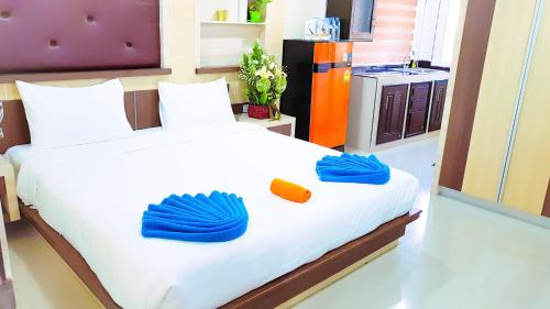 a bedroom with a large bed with blue mitts on it at Walking Street Residence - Boutique Suites near the Beach & Walking Street in Pattaya South
