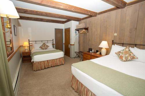 a hotel room with two beds and two lamps at Cristiana Guesthaus in Crested Butte