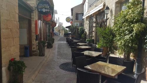 an alley with tables and chairs on a street at Chariandry Court in Pissouri