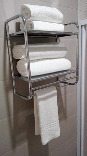 a group of towels on a towel rack in a bathroom at Casa do Rio in Alcácer do Sal