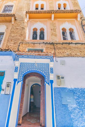 a blue and white building with a doorway at Dar Swiar in Chefchaouene