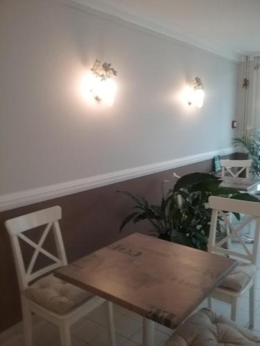 a dining room with a table and two chairs at Le Pigeonnier in Saint-Martin-le-Beau