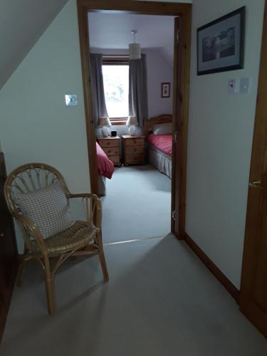 a room with a chair and a bed and a window at The Pally - behind 13 Palace Road, Kirkwall, Orkney - STL OR00122F in Kirkwall
