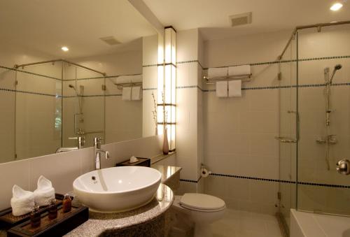 a bathroom with a sink and a toilet and a shower at Supalai Scenic Bay Resort And Spa, SHA Extra Plus in Por Bay