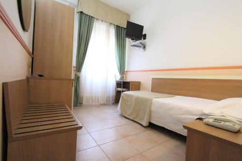 A bed or beds in a room at Hotel Corallo