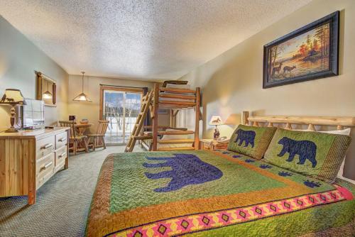a bedroom with a bed and a desk and a kitchen at Eagle River Inn and Resort in Eagle River