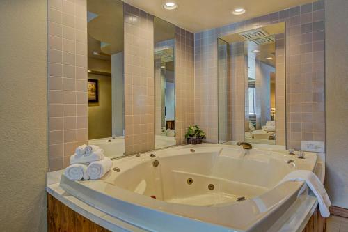 a large white tub in a bathroom with mirrors at Eagle River Inn and Resort in Eagle River