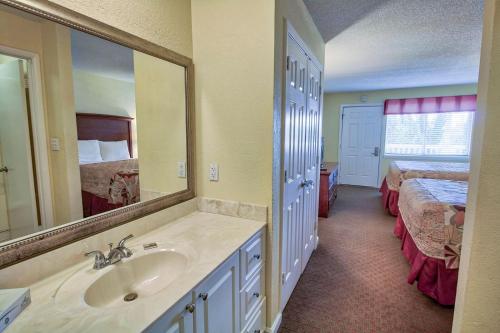 
a bathroom with a sink, mirror, and bathtub at Club Destin in Destin
