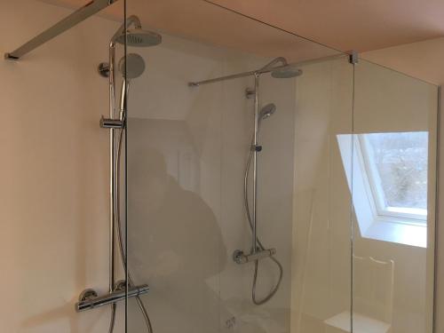 a bathroom with a shower with a glass door at Parkhotel Villa des Effats Vielsalm in Vielsalm