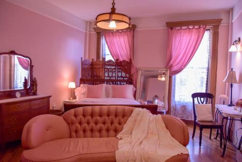 a large bedroom with a bed and a couch at Harlem Grand in New York