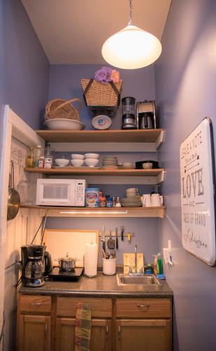 a kitchen with a sink and a microwave at Harlem Grand in New York