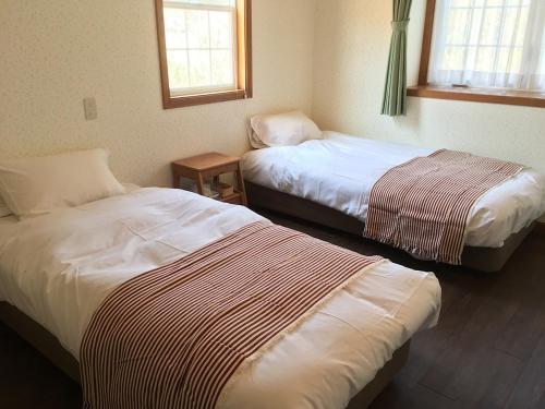 En eller flere senge i et værelse på Oli Oli Guesthouse