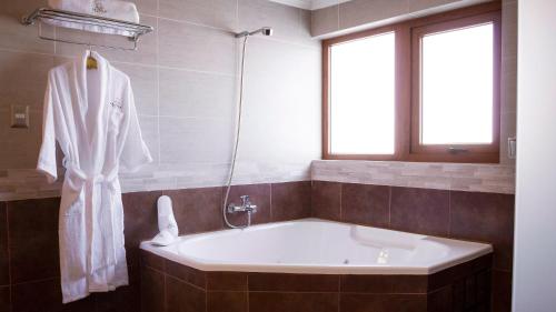a white bath tub in a bathroom with a window at La Perla Hotel in Santa Cruz