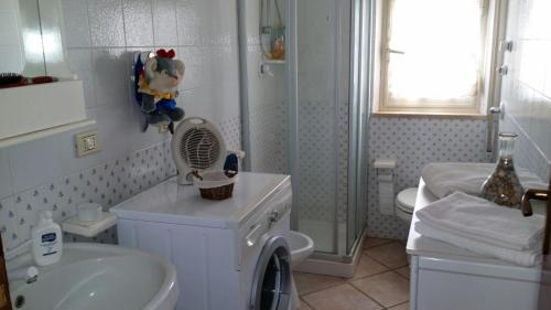 a bathroom with a shower and a sink and a toilet at Villetta al mare in Marausa