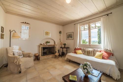 a living room with a couch and a fireplace at Villino Guest House in Akrotiri