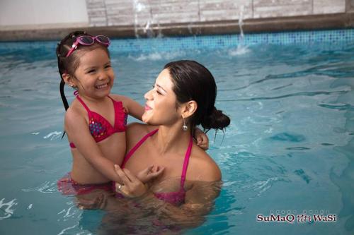 Eine Frau und ein kleines Mädchen im Schwimmbad. in der Unterkunft Sumaq Wasi Apart Hotel in Tacna