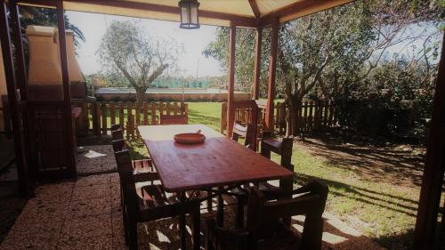 a wooden table and chairs under a tent at Podere Isabella in San Vincenzo