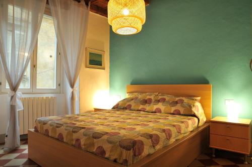 a bedroom with a bed and two night stands with lamps at FEEL - Arco Antico in Bergamo