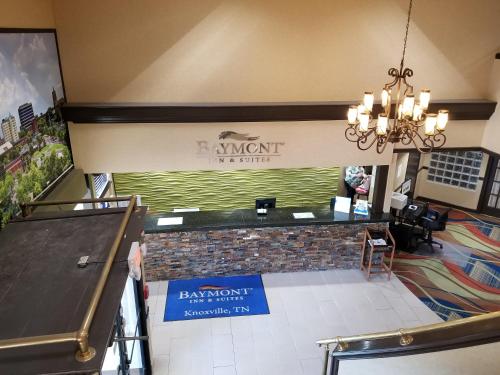 a bar in a restaurant with a sign on the wall at Baymont by Wyndham Knoxville I-75 in Knoxville