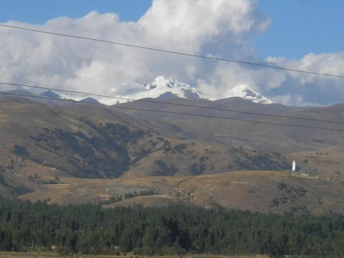 a snow capped mountain in the middle of a valley at Tour Hostal Wanka in Huancayo