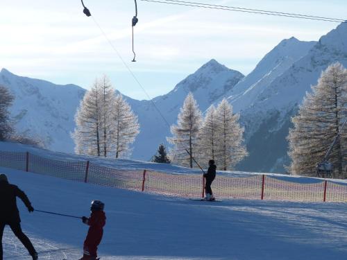 a group of people skiing on a snow covered slope at Conny's Ferienwohnungen in Gschnitz