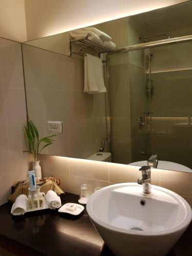 a bathroom with a sink and a large mirror at Elizabeth 1829 @ Wind Residences in Tagaytay