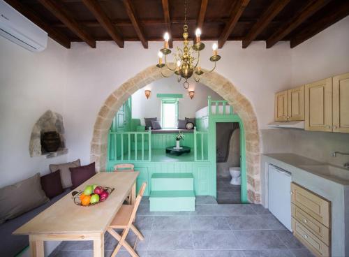 a kitchen with a table and a dining room at Hartso - Traditional loft, renovated former forge in Gennadi in Gennadi