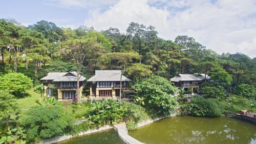 an aerial view of a resort with a pond at Melia Ba Vi Mountain Retreat in Hanoi