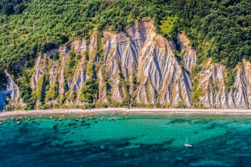an aerial view of a mountain with a body of water at Barbara Piran Beach Hotel in Piran
