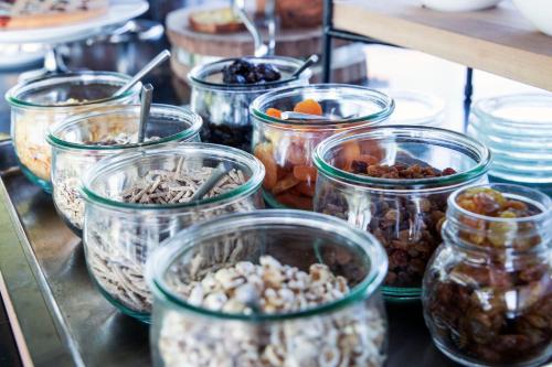 a bunch of jars filled with different types of food at Arborina Relais in La Morra