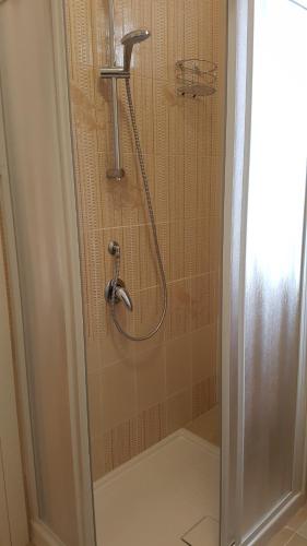 a shower with a shower head in a bathroom at Buio Pesto in Ceparana