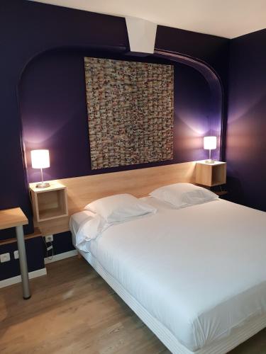 une chambre avec un grand lit blanc avec deux lampes dans l'établissement Transparent Marais, à Paris