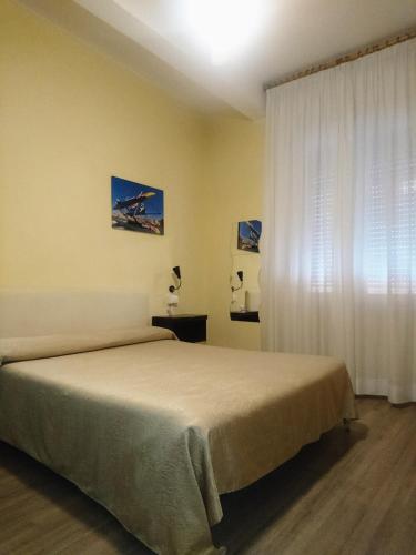 a bedroom with a bed and a window at Giappone Inn Parking Hotel in Livorno