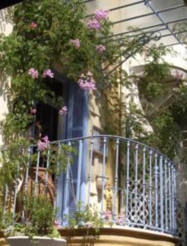 a balcony with pink flowers on a building at Villa Saint Hubert in Nice