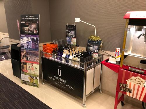 a store with a display of bottles of wine at Hotel U in Tokyo