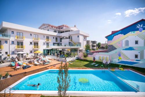 a large swimming pool in front of a building at Nayino Resort Hotel in Mamaia Nord