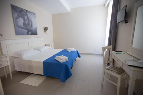 Postel nebo postele na pokoji v ubytování Hotel Grifo