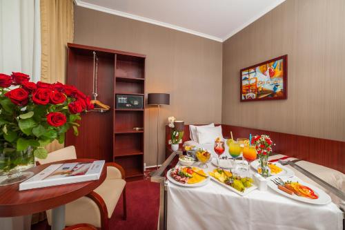 a hotel room with a table with food on it at Premier Kraków Hotel in Kraków