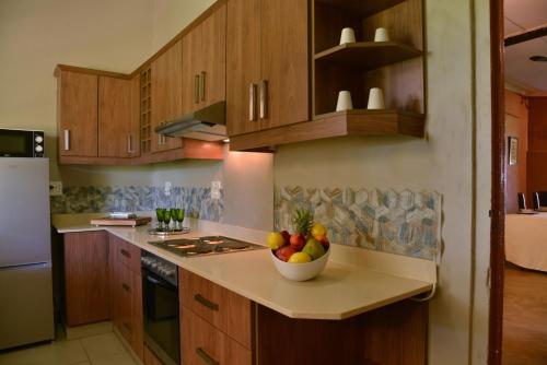 a kitchen with a bowl of fruit on a counter at Tala Collection Game Reserve in Silverton